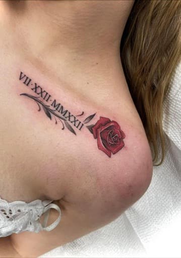 Roman numeral and rose tattoo — delicate fine line rose with elegant script lettering on collarbone