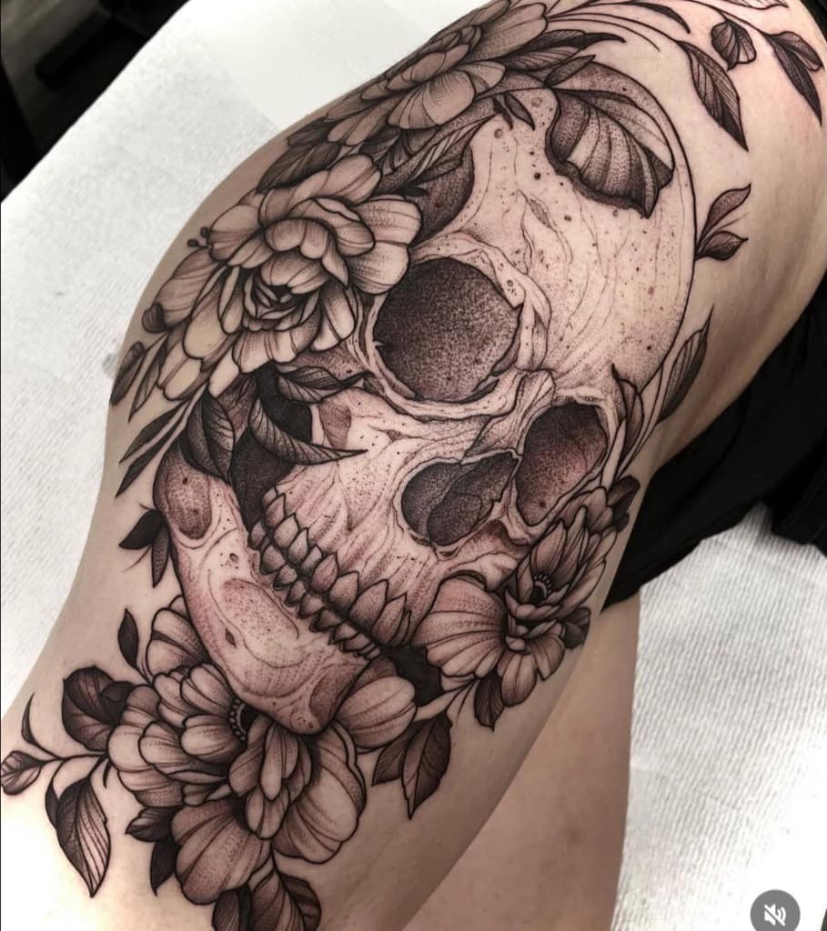 Skull and floral blackwork tattoo — detailed botanical skull piece with intricate florals and organic dotwork on thigh